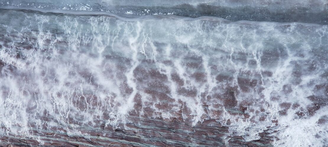 water waves hitting on brown wooden surface