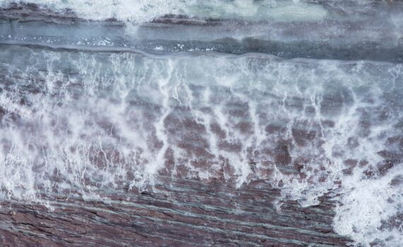 water waves hitting on brown wooden surface